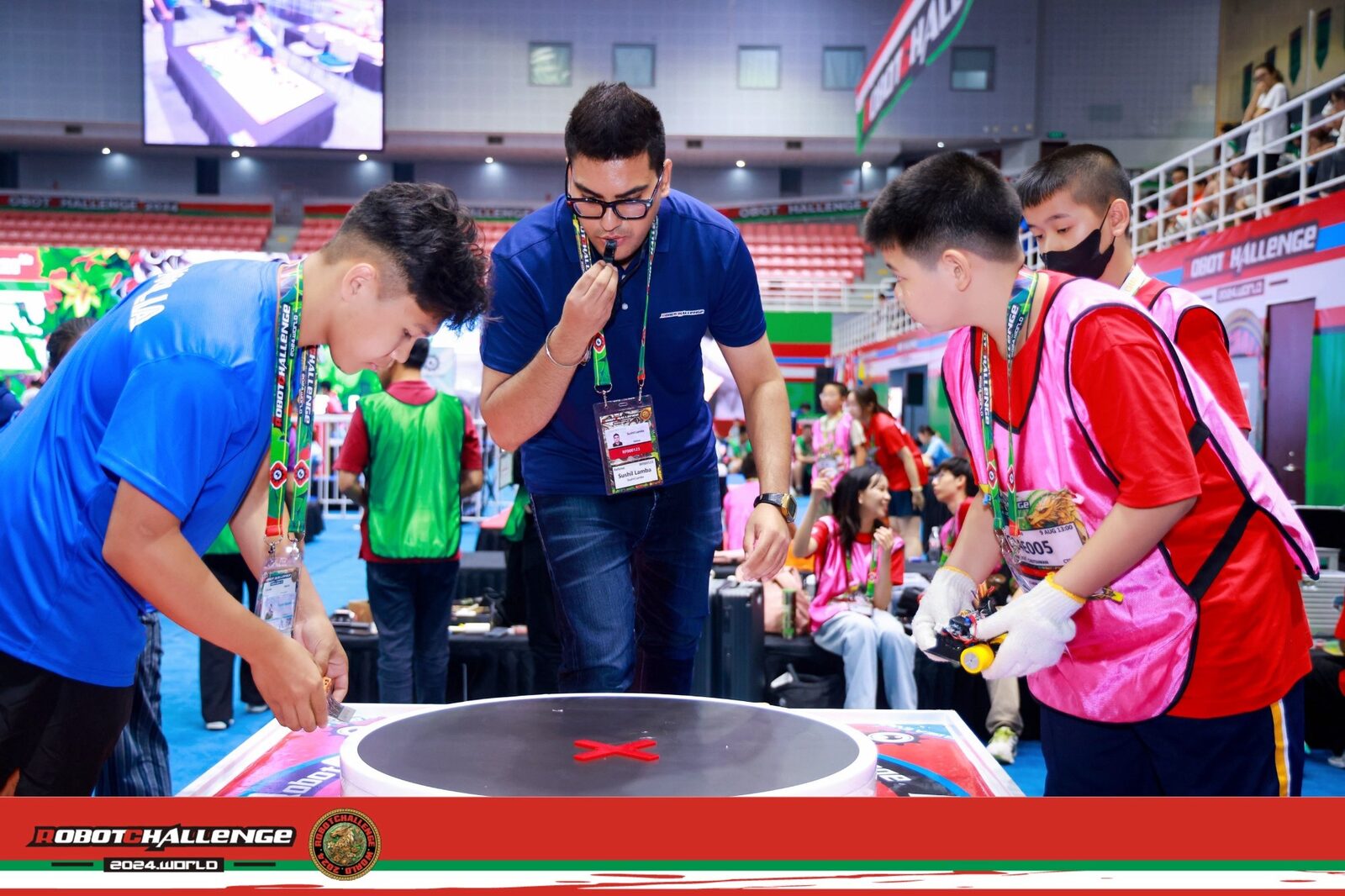 International robotics judge Sushil Lamba officiating Micro Sumo match at RobotChallenge World 2024